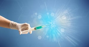 Female doctor hand holding syringe with shiny background