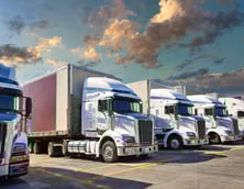 Firefly A blog post image of a fleet of American semi trucks in a parking lot 60114