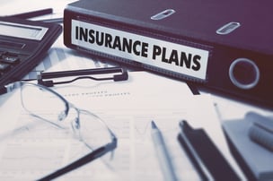Insurance Plans - Ring Binder on Office Desktop with Office Supplies. Business Concept on Blurred Background. Toned Illustration.